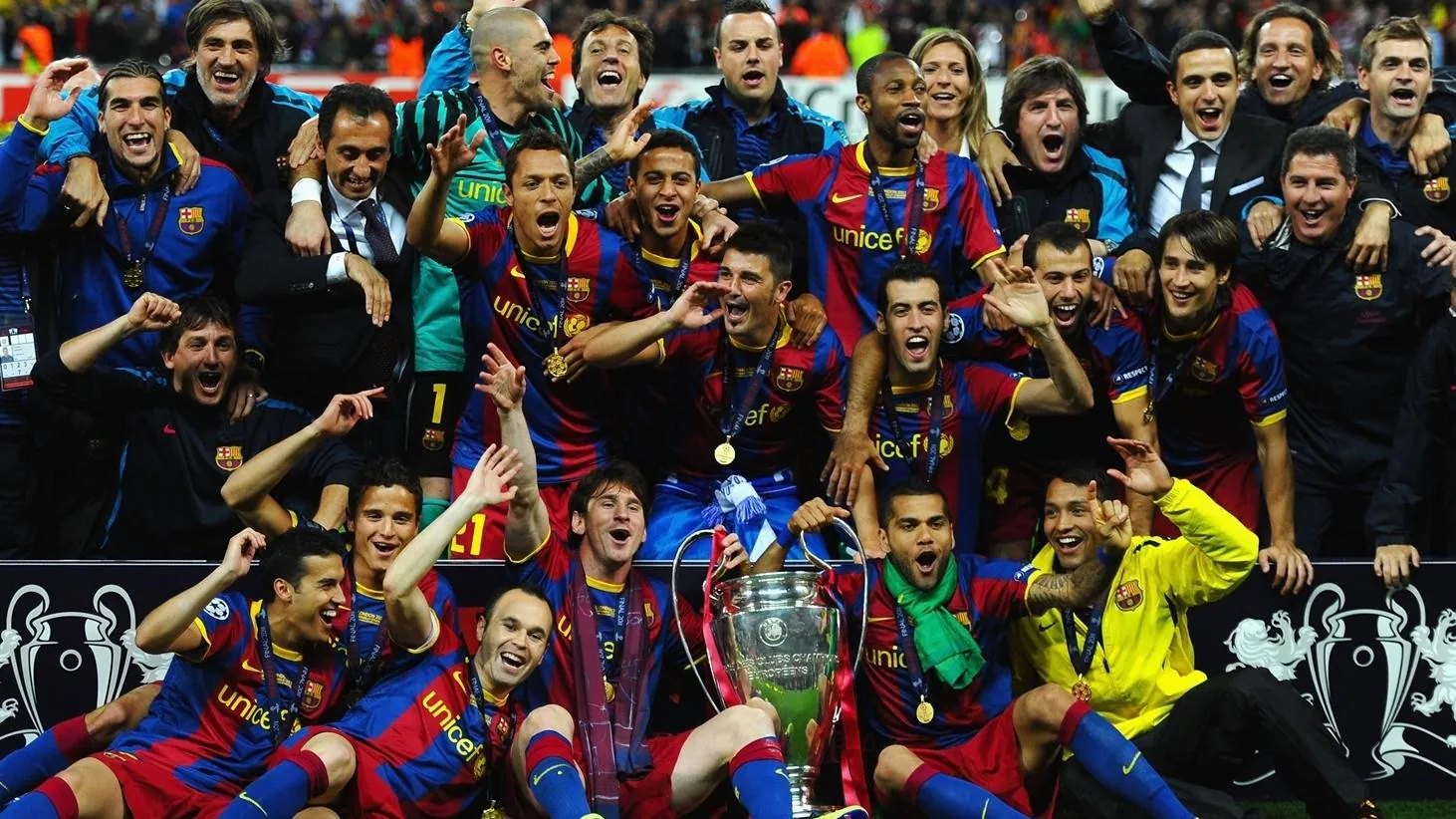 Barcelona players in their 2010/11 football shirts celebrating the Champions League win at Wembley