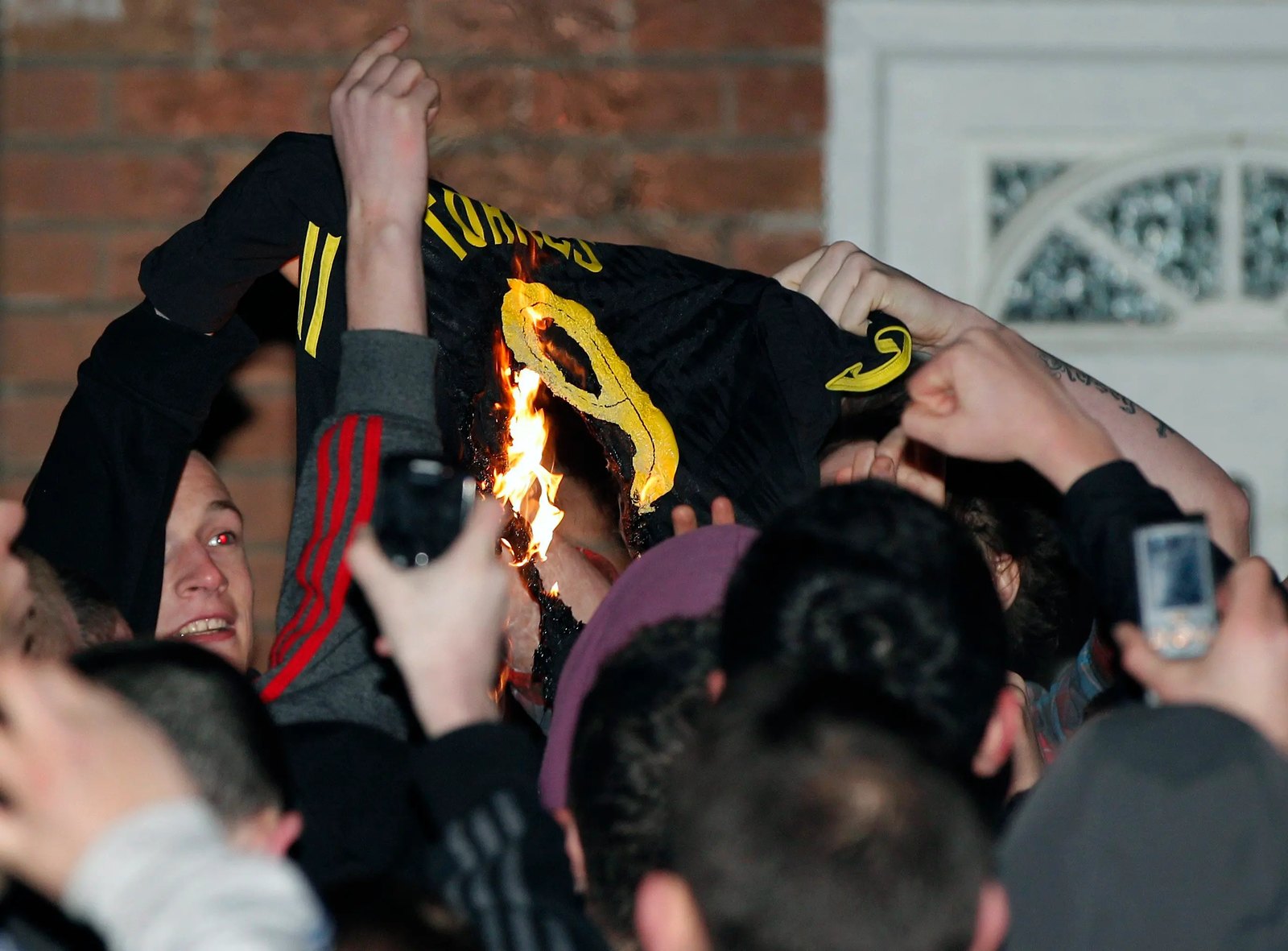 Fans burning a Torres 9 football shirt after his January transfer